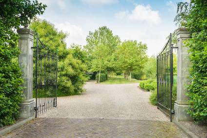 Wrought iron gate opening to estate home driveway